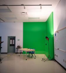 green screen is lit up in the corner of a classroom